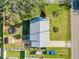 Aerial view of a home showcasing the roof, yard, shed, trampoline, and driveway at 1855 Needle Palm Dr, Edgewater, FL 32141