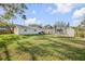 Well-maintained backyard with a shed, trampoline, and lush green grass at 1855 Needle Palm Dr, Edgewater, FL 32141