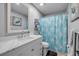 Bright bathroom features a vanity with carrara marble countertop and decorative unicorn shower curtain at 1855 Needle Palm Dr, Edgewater, FL 32141