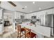 Modern kitchen with white cabinetry, stainless steel appliances, and a marble waterfall island with seating at 1855 Needle Palm Dr, Edgewater, FL 32141