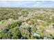 Aerial view of a property surrounded by trees, showing proximity to a main thoroughfare and the ocean at 1855 Needle Palm Dr, Edgewater, FL 32141