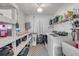 Well-lit laundry room with modern appliances, storage shelves and utility sink at 1855 Needle Palm Dr, Edgewater, FL 32141