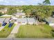 Aerial view of a well-maintained home with a large lawn, surrounded by mature trees in a quiet neighborhood at 1855 Needle Palm Dr, Edgewater, FL 32141