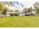 View of the backyard, showing the grassy space and the rear exterior of the home at 254 Tanner St, New Smyrna Beach, FL 32168