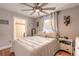 Cozy bedroom with neutral colors, wood floors, ceiling fan, and ensuite bathroom at 254 Tanner St, New Smyrna Beach, FL 32168