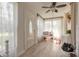 Sunlit entryway featuring tile floors, large windows with sheer curtains, and a comfortable bench at 254 Tanner St, New Smyrna Beach, FL 32168