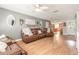 Relaxing living room featuring hardwood floors, comfortable sofas, and an open view to the kitchen at 254 Tanner St, New Smyrna Beach, FL 32168