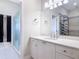 Bright bathroom featuring a vanity, mirror, towel rack, and glass door walk in shower at 2590 Erena Dr, New Smyrna Beach, FL 32168