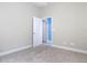 Neutral bedroom with carpet and access to other rooms of the house at 2590 Erena Dr, New Smyrna Beach, FL 32168