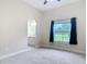 Bedroom with ensuite bathroom, lots of light from window, and neutral tones at 2590 Erena Dr, New Smyrna Beach, FL 32168