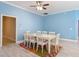 Dining room featuring blue walls and white trim with an area rug under the dining table at 2590 Erena Dr, New Smyrna Beach, FL 32168