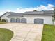 Aerial shot displaying the long driveway leading to the four-car garage and solar panels at 2590 Erena Dr, New Smyrna Beach, FL 32168