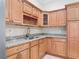 Well-lit kitchen featuring granite counters, wood cabinets, stainless steel undermount sink and chrome faucet at 2590 Erena Dr, New Smyrna Beach, FL 32168