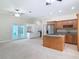 Open kitchen and living room showcasing island cooktop, stainless steel appliances and french doors to outdoor pool at 2590 Erena Dr, New Smyrna Beach, FL 32168