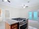 Kitchen island with cooktop and cabinets overlooking living room area with french door access to backyard pool at 2590 Erena Dr, New Smyrna Beach, FL 32168