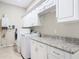 Laundry room with granite countertop, cabinetry, washer, and dryer hookups at 2590 Erena Dr, New Smyrna Beach, FL 32168