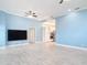 Spacious living room with light-colored walls, flooring, and a view to the kitchen at 2590 Erena Dr, New Smyrna Beach, FL 32168