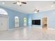 Bright living area with large windows, light floors, and an open layout with access to other rooms at 2590 Erena Dr, New Smyrna Beach, FL 32168