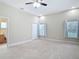 Large main bedroom with ensuite and neutral carpet at 2590 Erena Dr, New Smyrna Beach, FL 32168