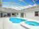 Indoor pool with adjacent hot tub and ample lighting at 2590 Erena Dr, New Smyrna Beach, FL 32168