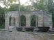 Historic ruins of a coquina building and sugar mill with arched windows, cauldrons and lush greenery at 26 Birdie Dr, New Smyrna Beach, FL 32168