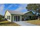 Charming single-story home with a well-manicured lawn, sliding door access, and a classic look at 26 Birdie Dr, New Smyrna Beach, FL 32168