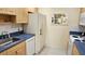 Bright kitchen with a stainless steel sink and white appliances; a functional design at 26 Birdie Dr, New Smyrna Beach, FL 32168