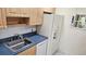 This bright kitchen features white appliances and wood cabinets at 26 Birdie Dr, New Smyrna Beach, FL 32168