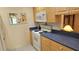 This kitchen features a white oven with cooktop and dark countertops at 26 Birdie Dr, New Smyrna Beach, FL 32168