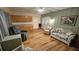 Relaxing living room with wood floors, ceiling fan, and a sofa near glass paneled doors at 26 Birdie Dr, New Smyrna Beach, FL 32168