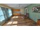 Cozy living room with beautiful wood flooring and light green walls providing ample space for relaxation at 26 Birdie Dr, New Smyrna Beach, FL 32168