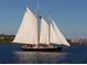 Classic sailboat sailing on the water on a clear day, offering a glimpse of a relaxing maritime lifestyle at 26 Birdie Dr, New Smyrna Beach, FL 32168