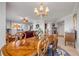 Elegant dining area featuring a chandelier, wooden table, with a view of the living area and outdoor scenery at 263 Minorca Beach Way # 801, New Smyrna Beach, FL 32169