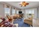 Bright living room featuring a ceiling fan, comfortable seating, and sliding glass doors to the outside at 263 Minorca Beach Way # 801, New Smyrna Beach, FL 32169