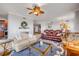 Inviting living room featuring a fireplace, comfortable seating, a ceiling fan, and an open layout at 263 Minorca Beach Way # 801, New Smyrna Beach, FL 32169