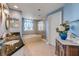 Bright main bathroom with a soaking tub, double sinks, and elegant tile work at 263 Minorca Beach Way # 801, New Smyrna Beach, FL 32169