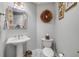 Stylish powder room with decorative mirror, pedestal sink, and tasteful accents at 263 Minorca Beach Way # 801, New Smyrna Beach, FL 32169