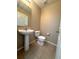 Half bathroom with a pedestal sink, toilet, and tile flooring at 2669 Sicily Dr, New Smyrna Beach, FL 32168