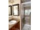 Bathroom featuring a vanity with a large mirror and tiled shower at 2669 Sicily Dr, New Smyrna Beach, FL 32168