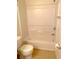 Clean bathroom with a tub and shower combo and a modern toilet at 2669 Sicily Dr, New Smyrna Beach, FL 32168