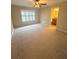 Bedroom featuring carpet, a ceiling fan, and a window with plantation shutters at 2669 Sicily Dr, New Smyrna Beach, FL 32168