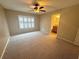 Bedroom with carpet, a ceiling fan, and a window with plantation shutters at 2669 Sicily Dr, New Smyrna Beach, FL 32168