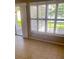 Bright living room featuring tile flooring, large windows, and neutral walls at 2669 Sicily Dr, New Smyrna Beach, FL 32168