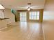 Bright living room with tile flooring, ceiling fan, and sliding glass doors to patio at 2669 Sicily Dr, New Smyrna Beach, FL 32168