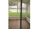 Screened patio with a view of a serene lake and lush green lawn at 2669 Sicily Dr, New Smyrna Beach, FL 32168