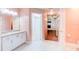 Bright bathroom with white vanity and view to walk in closet at 2708 Turnbull Estates Dr, New Smyrna Beach, FL 32168