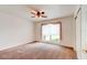 Spacious bedroom with neutral carpet, ceiling fan, and bright window at 2708 Turnbull Estates Dr, New Smyrna Beach, FL 32168