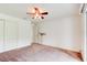 Bedroom featuring fan, carpeting, and closet at 2708 Turnbull Estates Dr, New Smyrna Beach, FL 32168