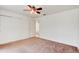 Bedroom with plush carpeting, ceiling fan, and closet at 2708 Turnbull Estates Dr, New Smyrna Beach, FL 32168