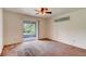 Bright bedroom with sliding glass doors leading to a screened lanai and a ceiling fan fixture at 2708 Turnbull Estates Dr, New Smyrna Beach, FL 32168